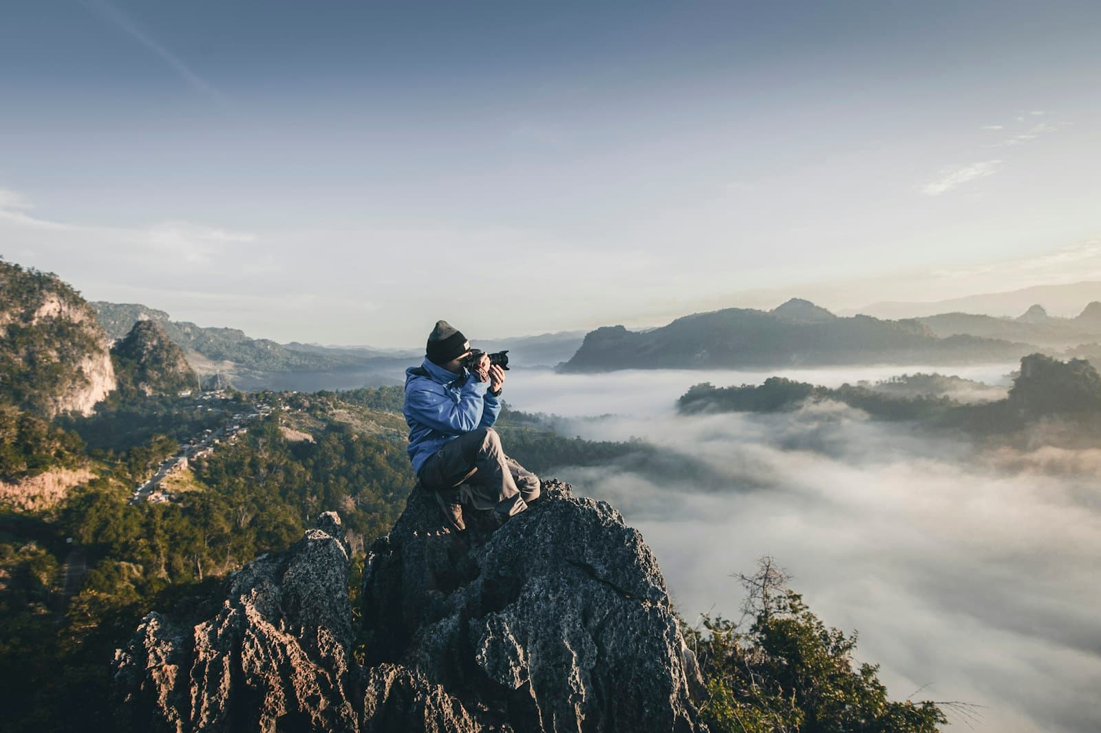 A photographer shooting above the clouds at sunrise