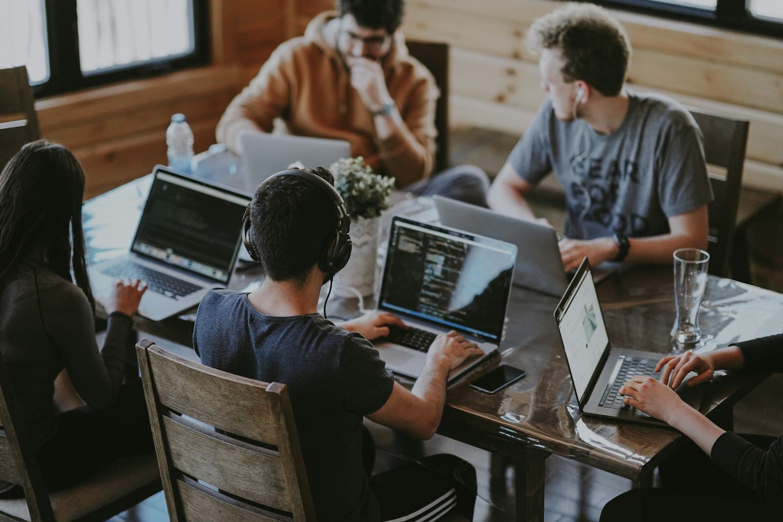 A founding team working around one table on laptops