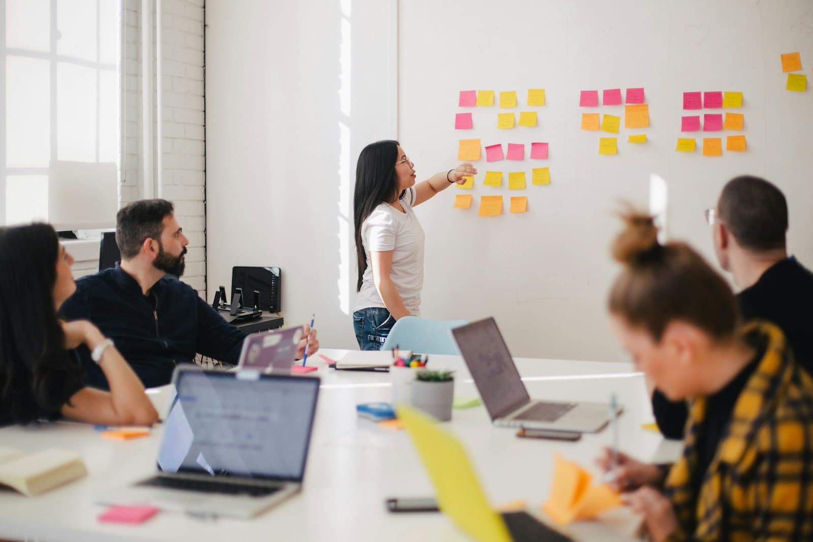 A team planning a campaign with sticky notes on a wall